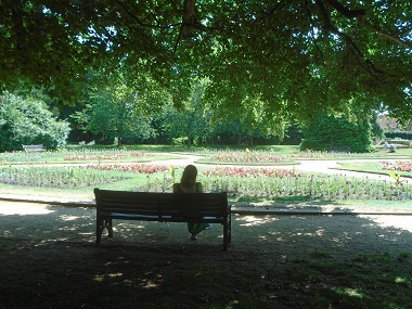 Person sitting in the shade and overlooking the formal garden.