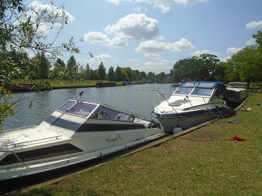Boats moor by the meadow