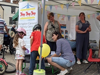 Children visiting the Abingdon Carousel stand